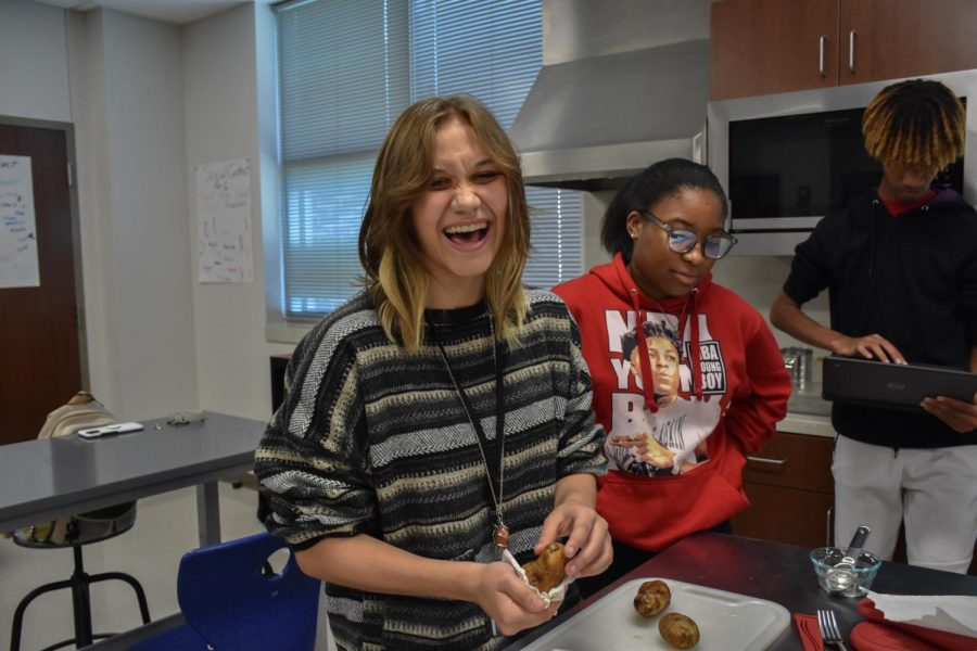 Grey Ortiz (10) is laughing while drying potatoes, while Kennedi Brooks (10) and Alex Anderson (10) are waiting for her to be done.