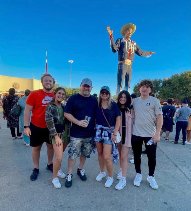 Student, Abby Amick (10), stands in front of Big Tex with her family at the State Fair of Texas. Amick explains her favorite festivities to do while at the fair. I like to play arcade games and [go through] funhouses, Amick said.