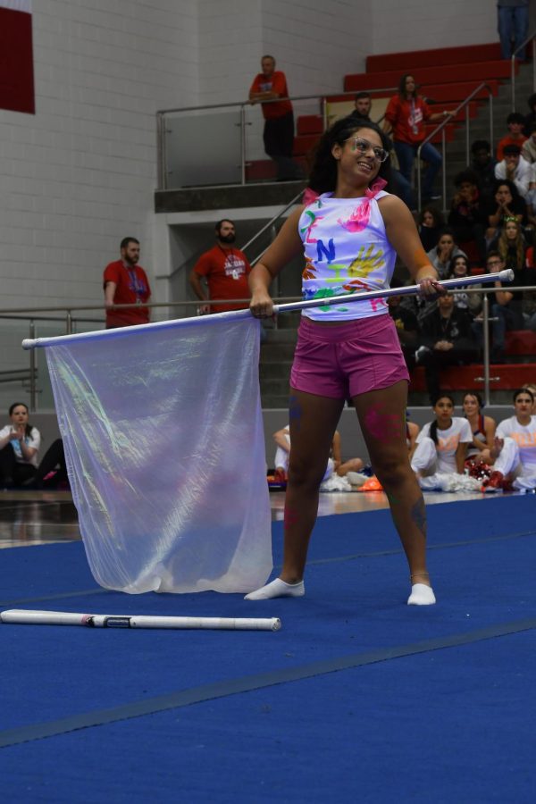 Emily Oliveros (12) is performing the flag portion of her senior routine.