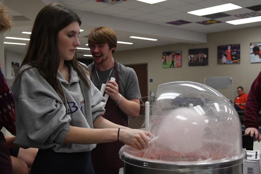 Alexandra Schmidt (12) and Luke Howard (12) are making cotton candy.