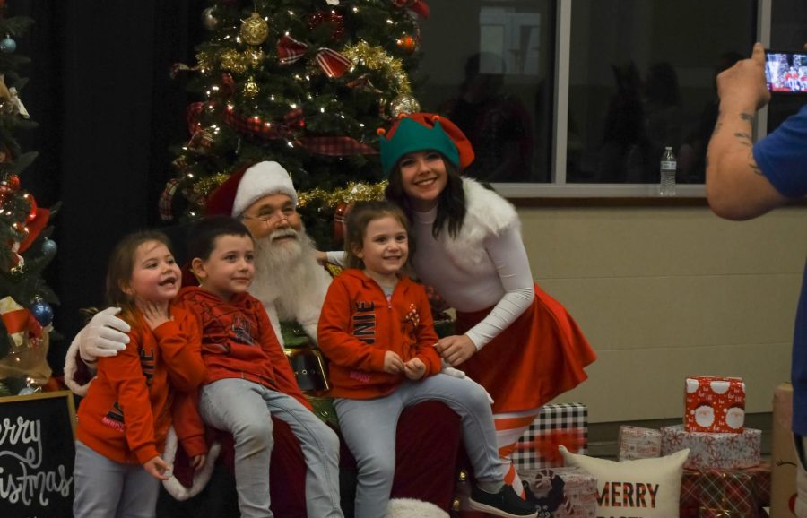 Madeline Jones (11) is posing with Santa and some kids.