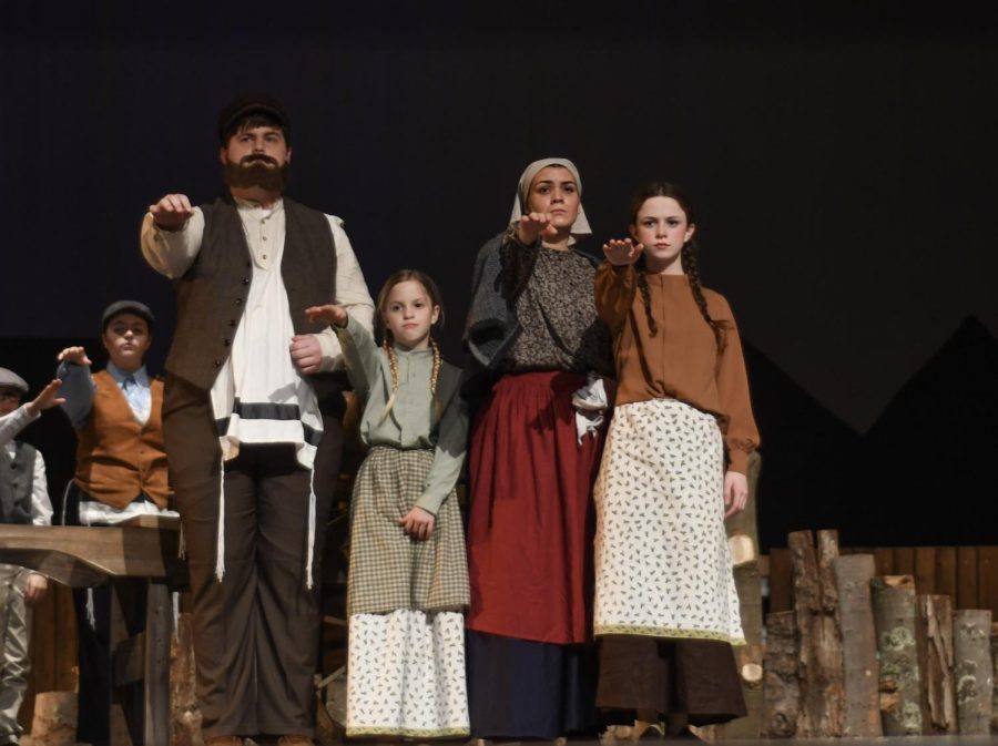 Isaac George (12), Rebecca Holland (12), and the child actors are preparing to leave Anatevka.