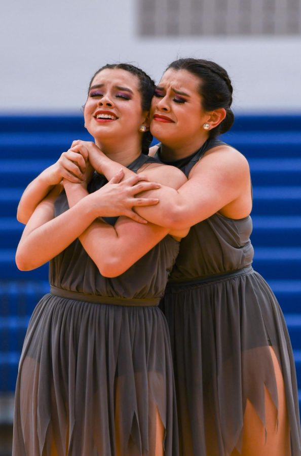 Alisia Castillo (11) and Amelia Castillo (11) are embracing as a part of their dance.