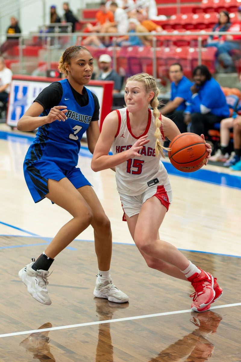 Guard Ivy Preusser (12) drives to the hoop against a Brewer defender in the Heritage Hoopfest championship game. The Jags took second place in the tournament. 

- @KenMurphyPhoto